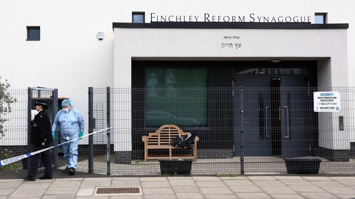 Police forensics officer examining Finchley Reform Synagogue after attempted arson attack
