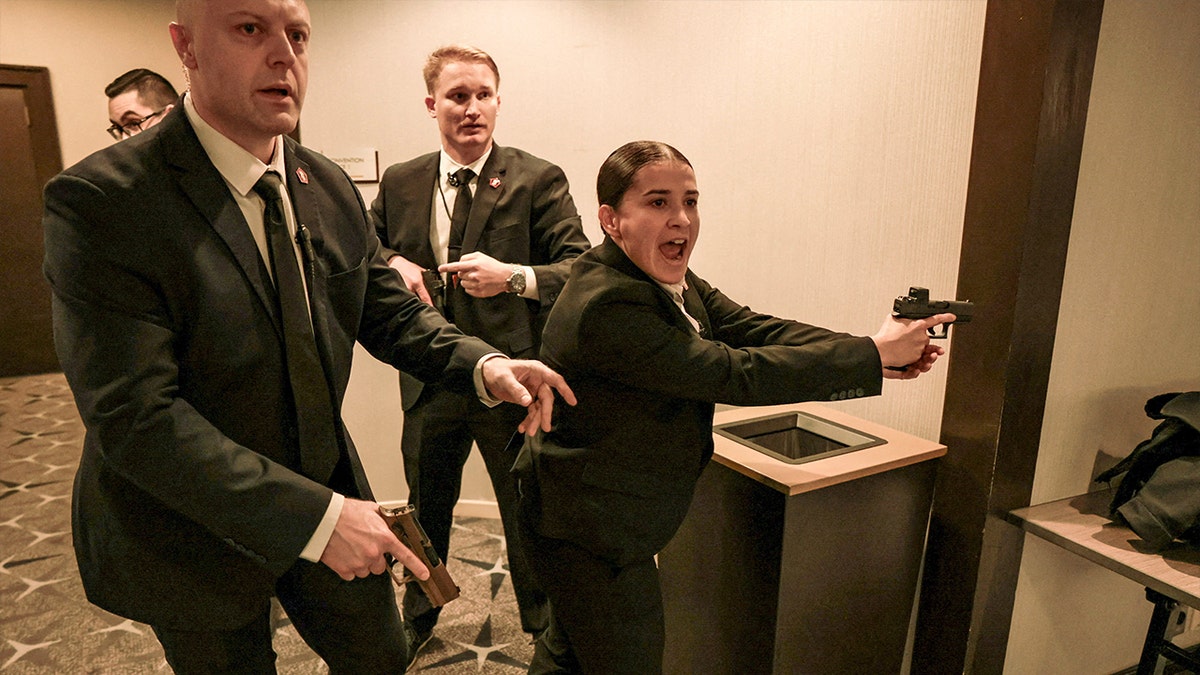 Security officials react as a shooter opens fire during the annual White House Correspondents' Association dinner in Washington, D.C., U.S., April 25, 2026.