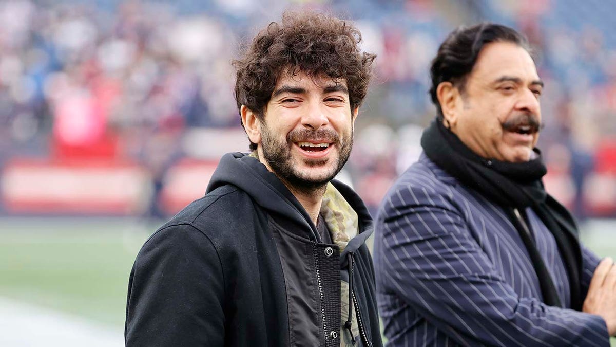 Jacksonville Jaguars owners Tony and Shad Khan standing on the sidelines at Gillette Stadium