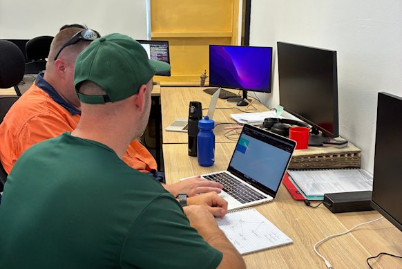 Josh, with another inmate, during a coding lesson. 