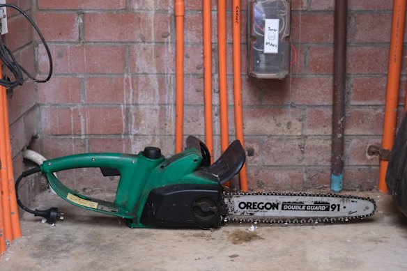 Viki Graham has various items outside her Balmain unit including stacked pieces of beds and luggage as well as this chainsaw.