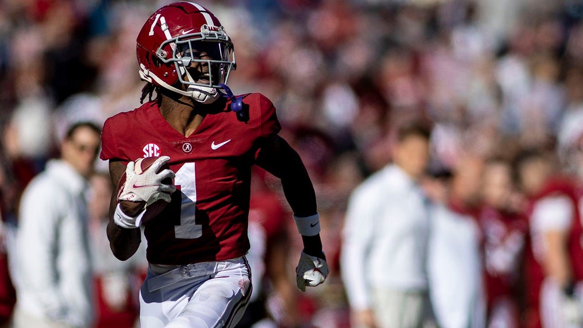 Alabama wide receiver Jameson Williams running down the sideline during a football game