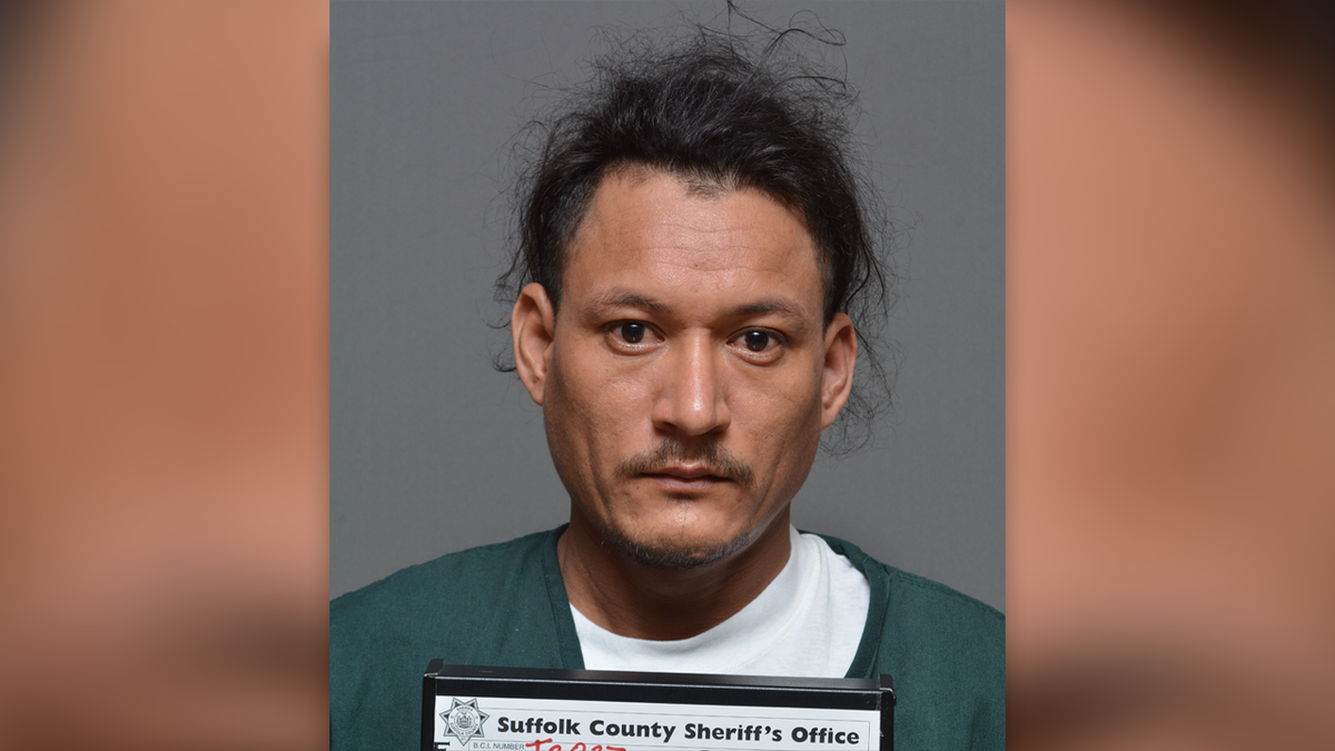 Jose Ignacio Bonilla Garcia wearing a green jail shirt over a white undershirt in his booking photo at the Suffolk County Jail in Riverhead, New York.