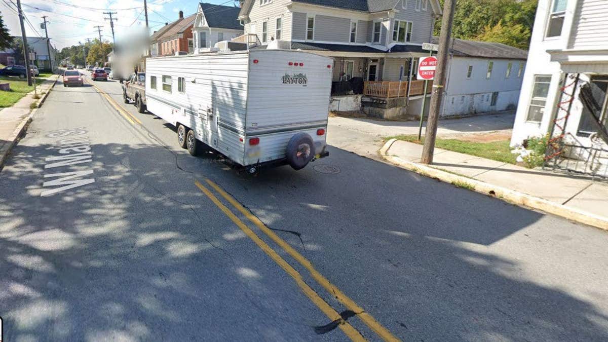 A Google Maps screenshot of W. Main Street in Windsor, Pennsylvania showing a trailer driving on a blacktop road divided by a double yellow line.
