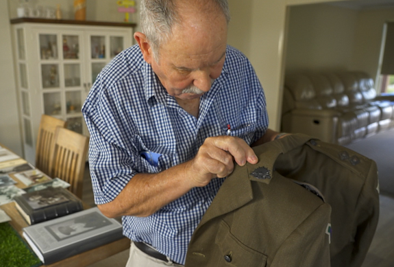 Stan’s son John Walsh with his father’s original Rat of Tobruk jacket, still in perfect condition.