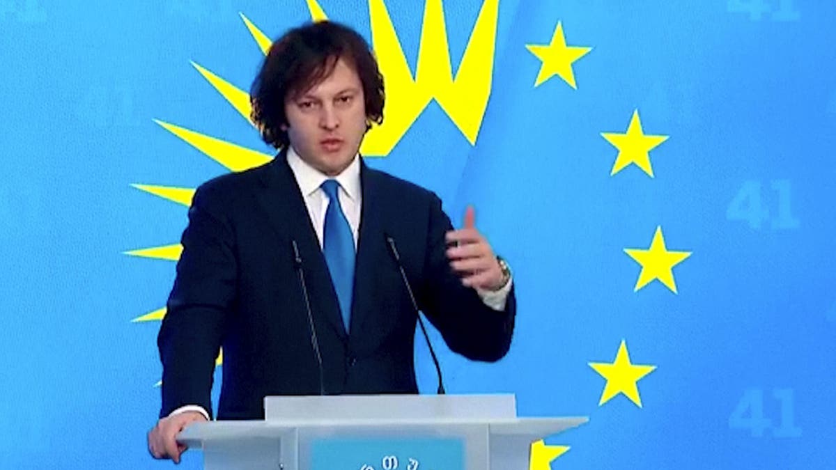 Georgian Prime Minister Irakli Kobakhidze speaking at a podium in Tbilisi