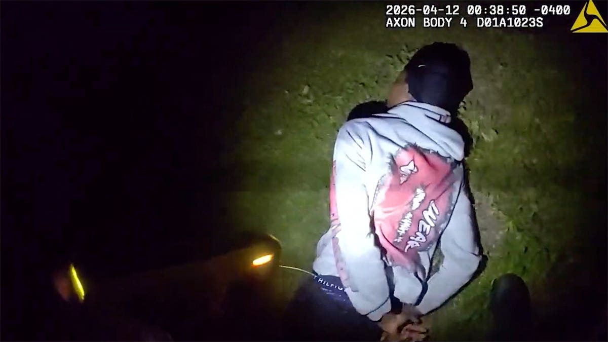 An individual being taken into custody by police officers in Atlanta