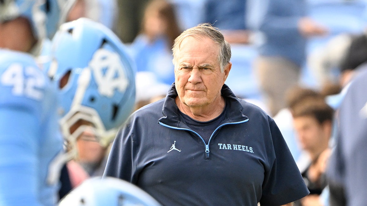 North Carolina Tar Heels head coach Bill Belichick standing with the team at Kenan Stadium