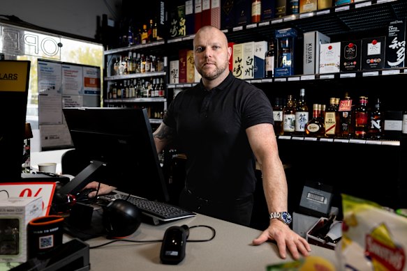 Chris Thompson inside his bottle shop on Atherton Road.