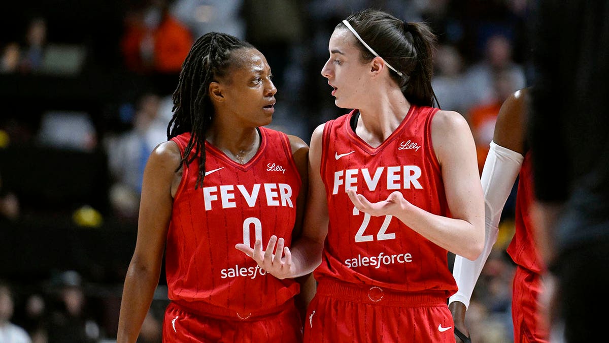 Indiana Fever guards Kelsey Mitchell and Caitlin Clark talking on basketball court