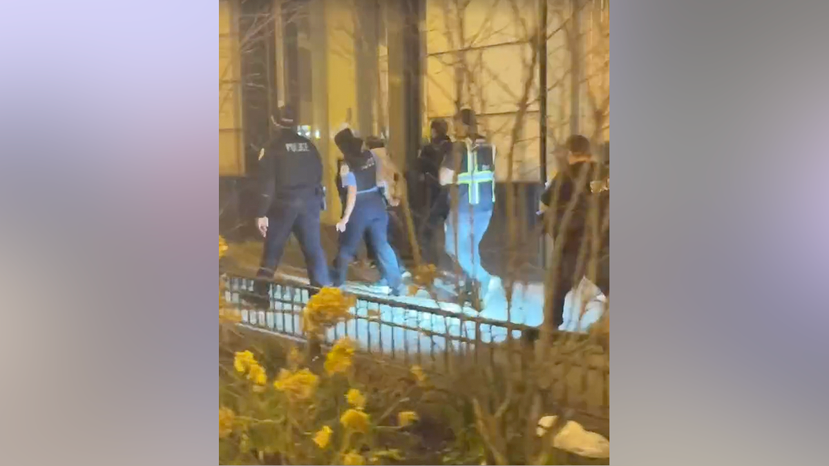 Chicago police detaining an individual during a teen takeover in the Loop