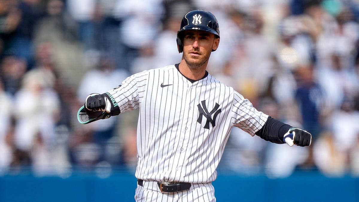 New York Yankees' Cody Bellinger gestures after hitting a double during a baseball game.