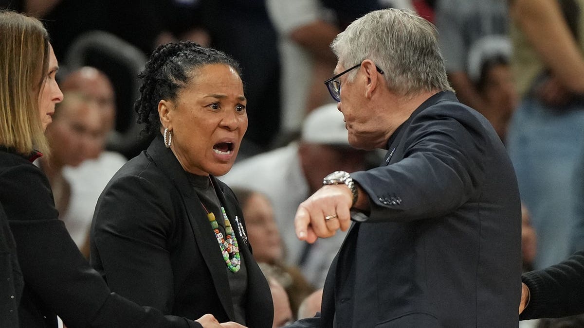 South Carolina head coach Dawn Staley and UConn head coach Geno Auriemma arguing on basketball court