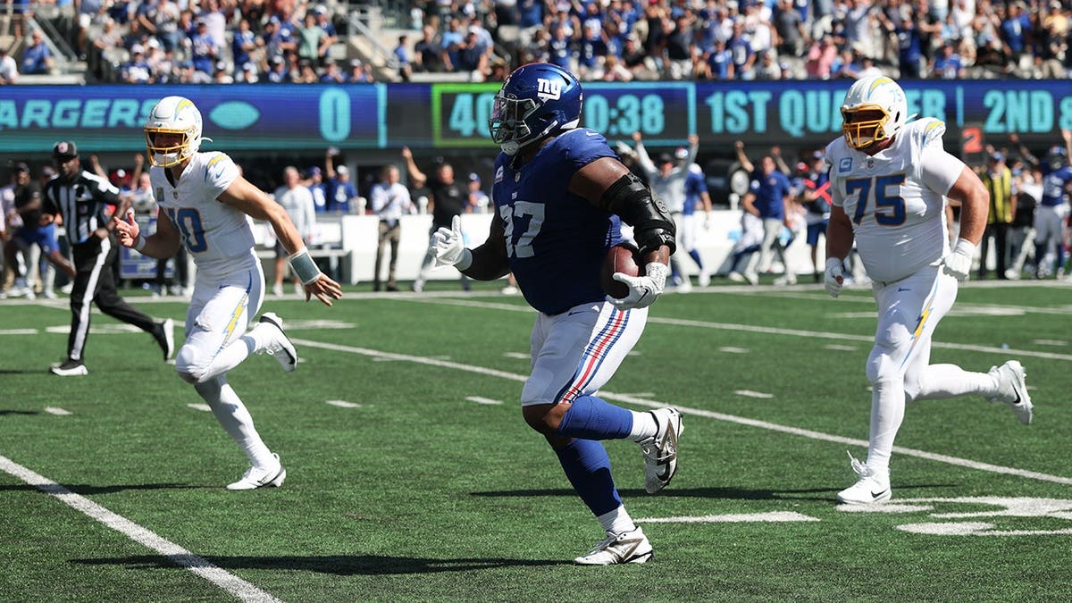 New York Giants defensive tackle Dexter Lawrence II returning an interception at MetLife Stadium