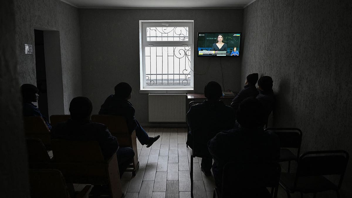 Nationals of African countries watching television in a detention center in western Ukraine