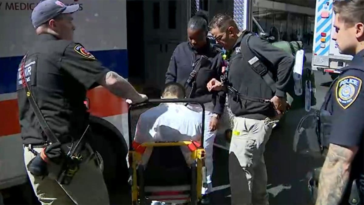 Police surrounding a man in a wheelchair