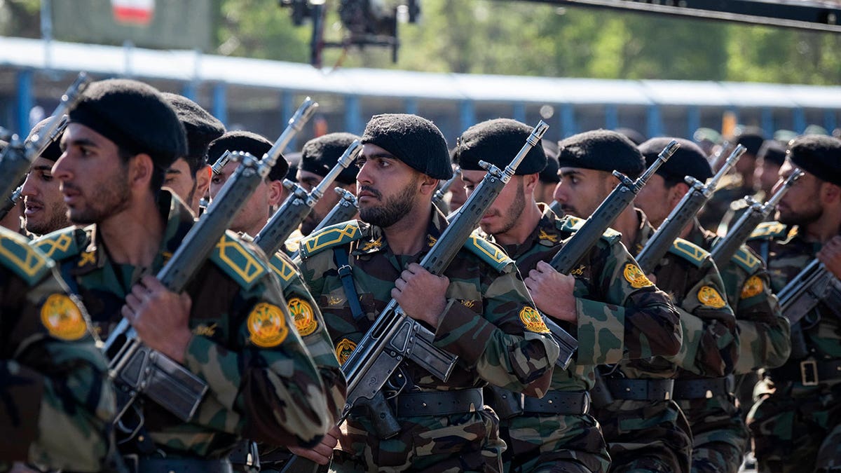 Iranian armed military forces marching in a parade outside the Khomeini Shrine in Tehran