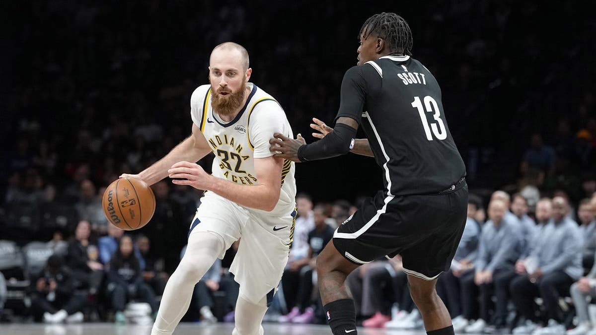 Indiana Pacers center Jay Huff dribbling basketball against Brooklyn Nets forward Trevon Scott at Barclays Center