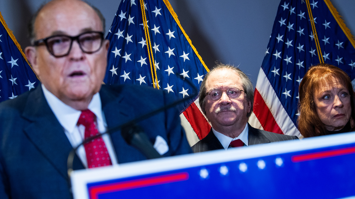 Rudy Giuliani is seen alongside Joseph diGenova during a news conference at the RNC.
