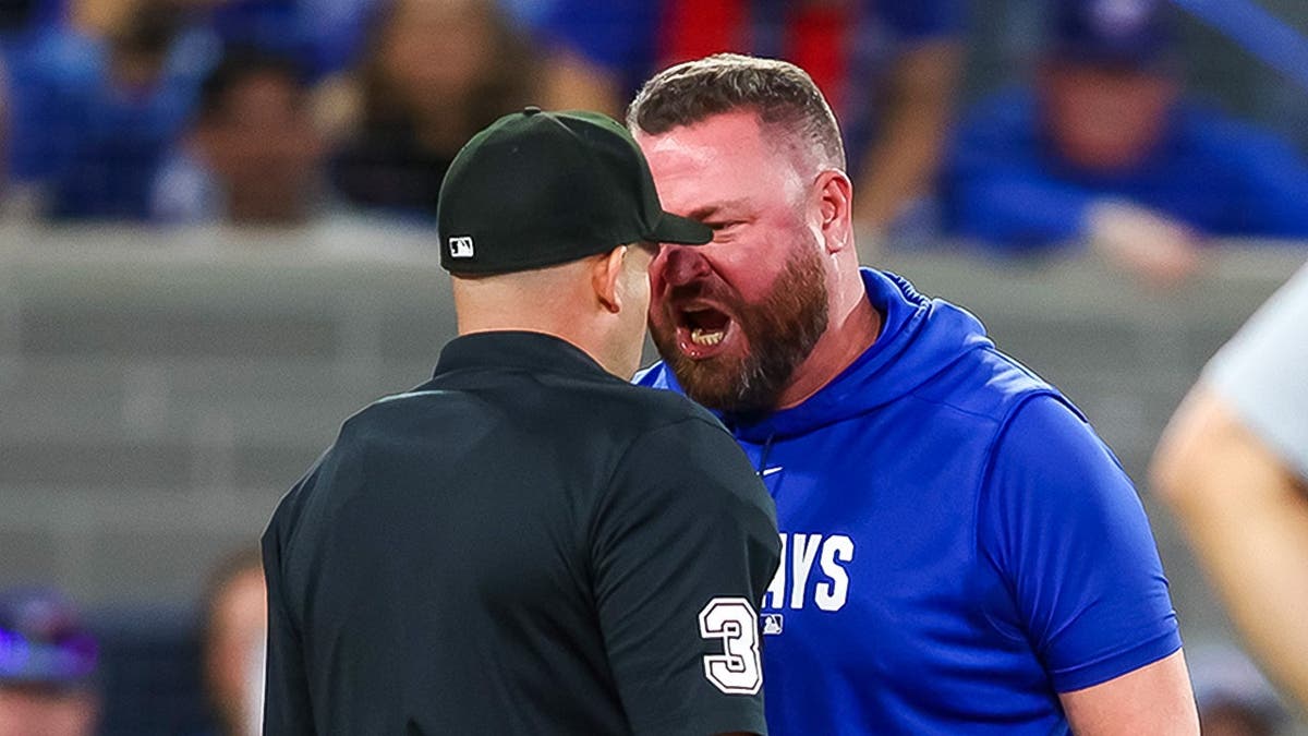 John Schneider yelling at umpire Dan Merzel during a baseball game at Rogers Centre