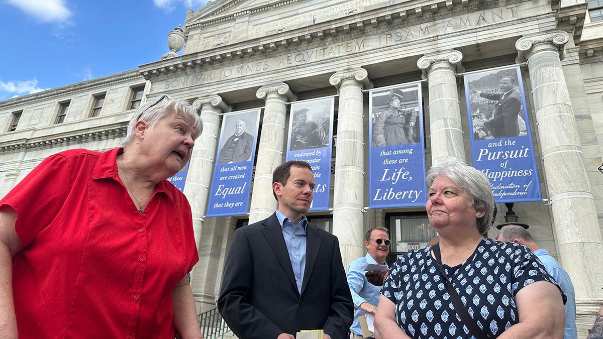 Judy Prichard McCleary and Greg Prichard speaking outside Delaware County Courthouse in Media, Pennsylvania