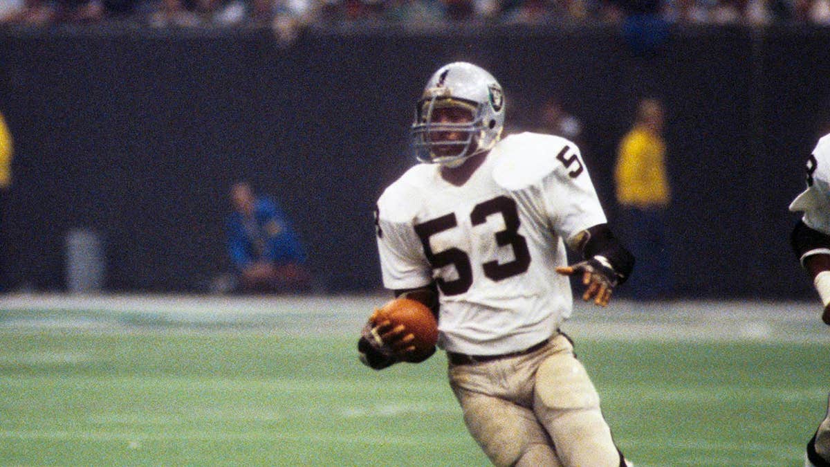 Oakland Raiders linebacker Rod Martin carrying the ball after an interception in the Superdome