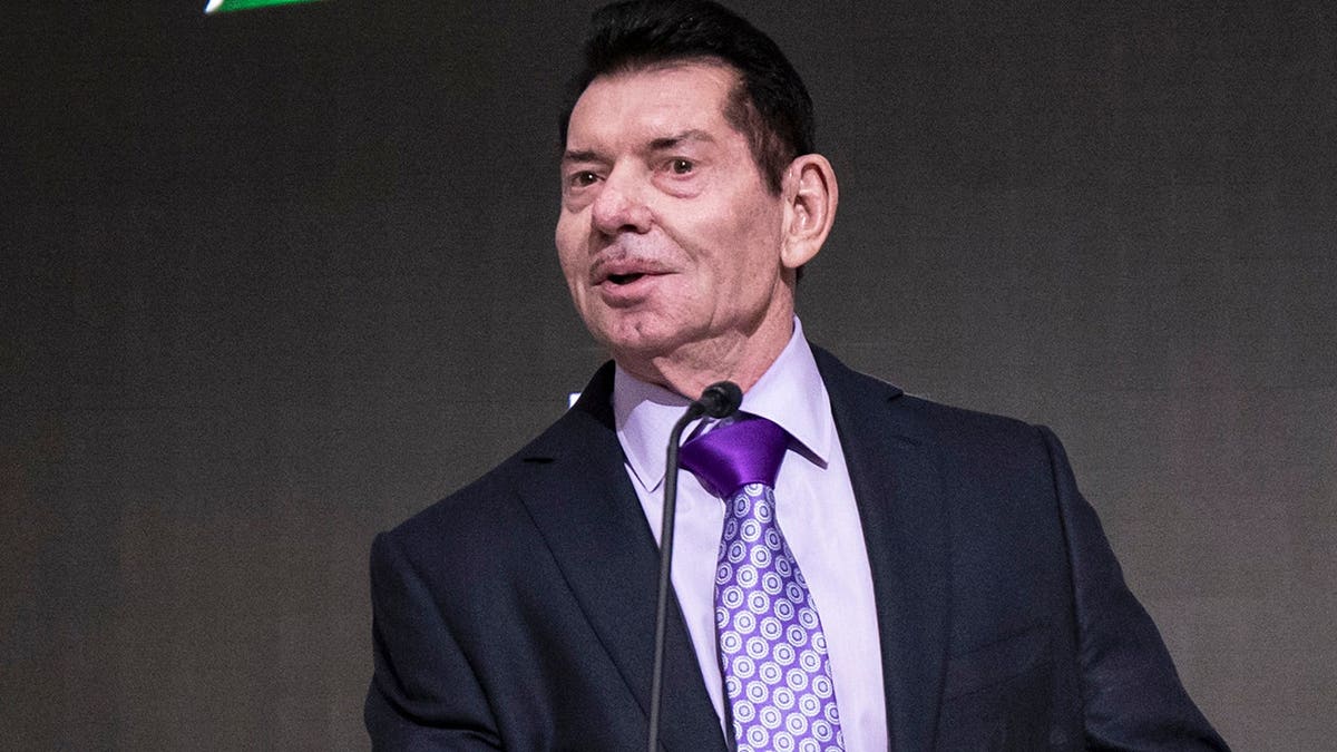 Vince McMahon standing at a podium during a ceremony at the New York Stock Exchange
