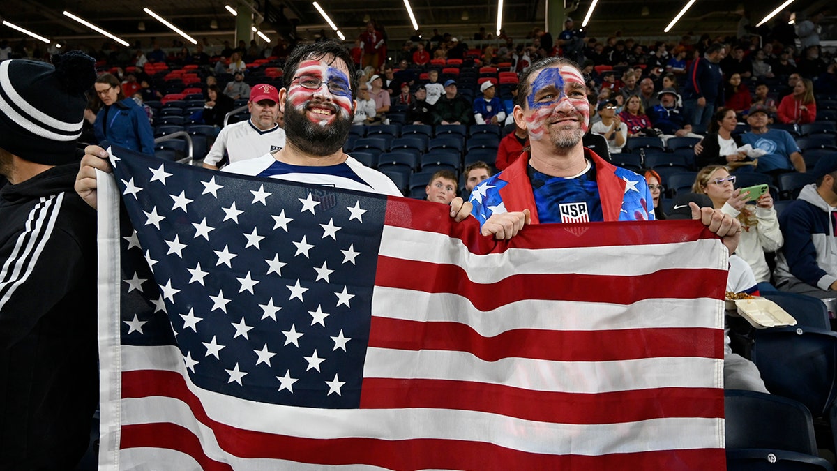 US fans holding an American flag at Citypark stadium in St. Louis Missouri