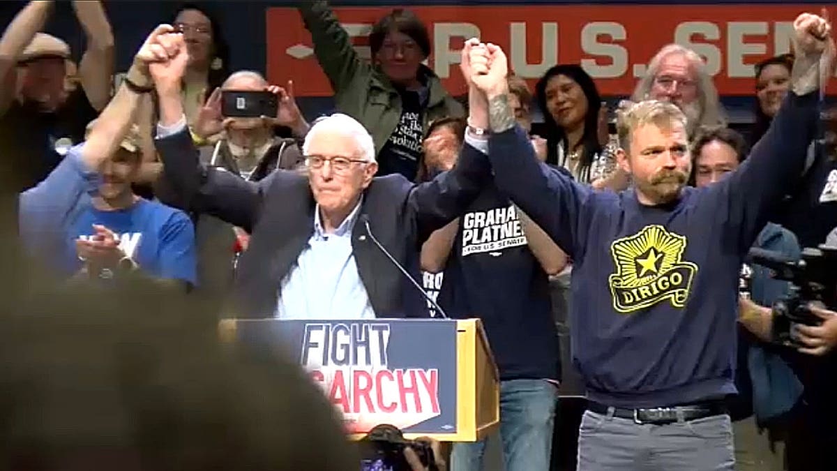 Bernie Sanders raising Graham Platner's hand