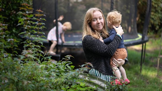 Kate with her two youngest children in her Medlow Baths home, which has high levels of PFAS in the soil.