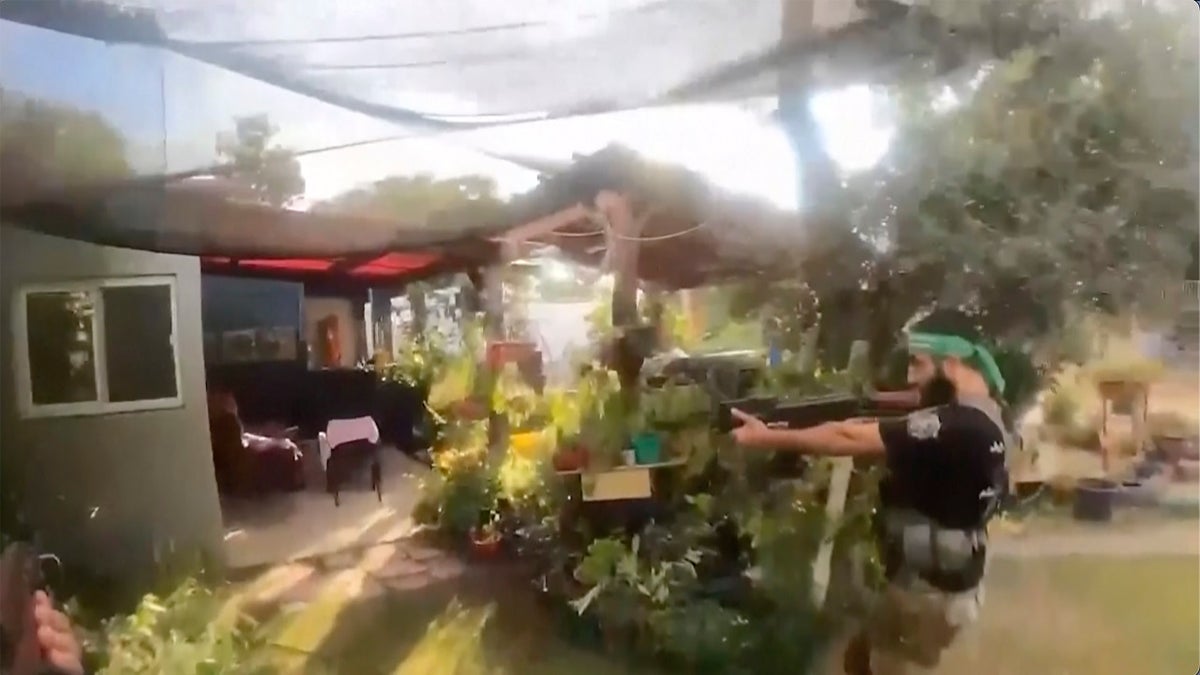 A Hamas terrorist walking in a residential neighborhood in southern Israel