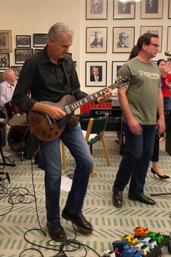 Tony Burke on guitar and Veterans’ Affairs Minister Matt Keogh singing in the Labor Party caucus room in the band Left Right Out.