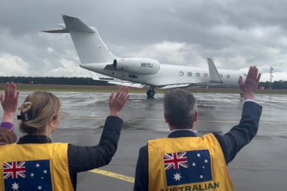 Australian officials farewell a plane carrying passengers from a cruise ship hit by a hantavirus outbreak as it departs the Netherlands on Thursday, May 14. 