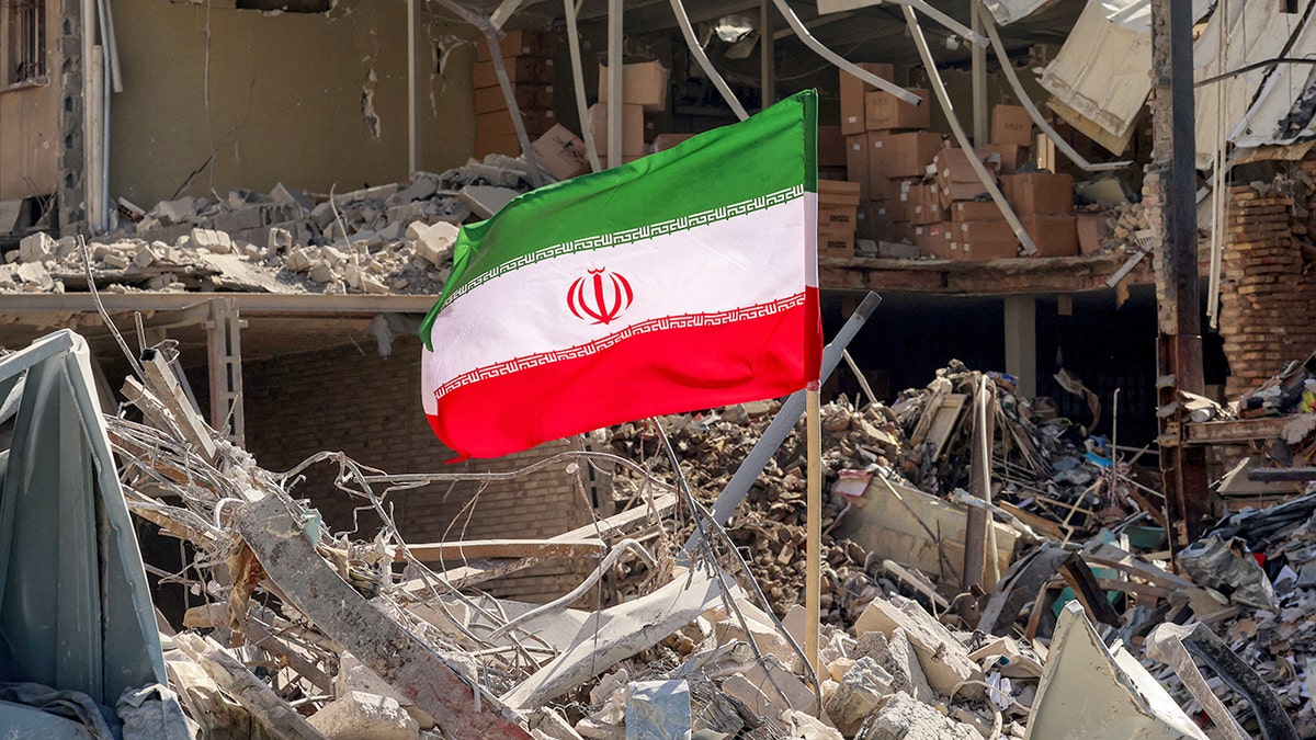 Iranian flag amid rubble