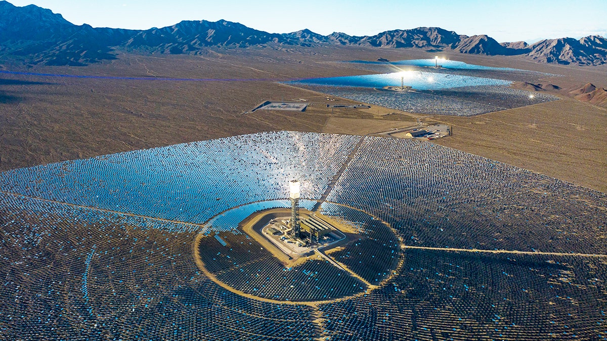 Aerial view of Ivanpah Solar Power Plant with mirrors reflecting sunlight onto towers