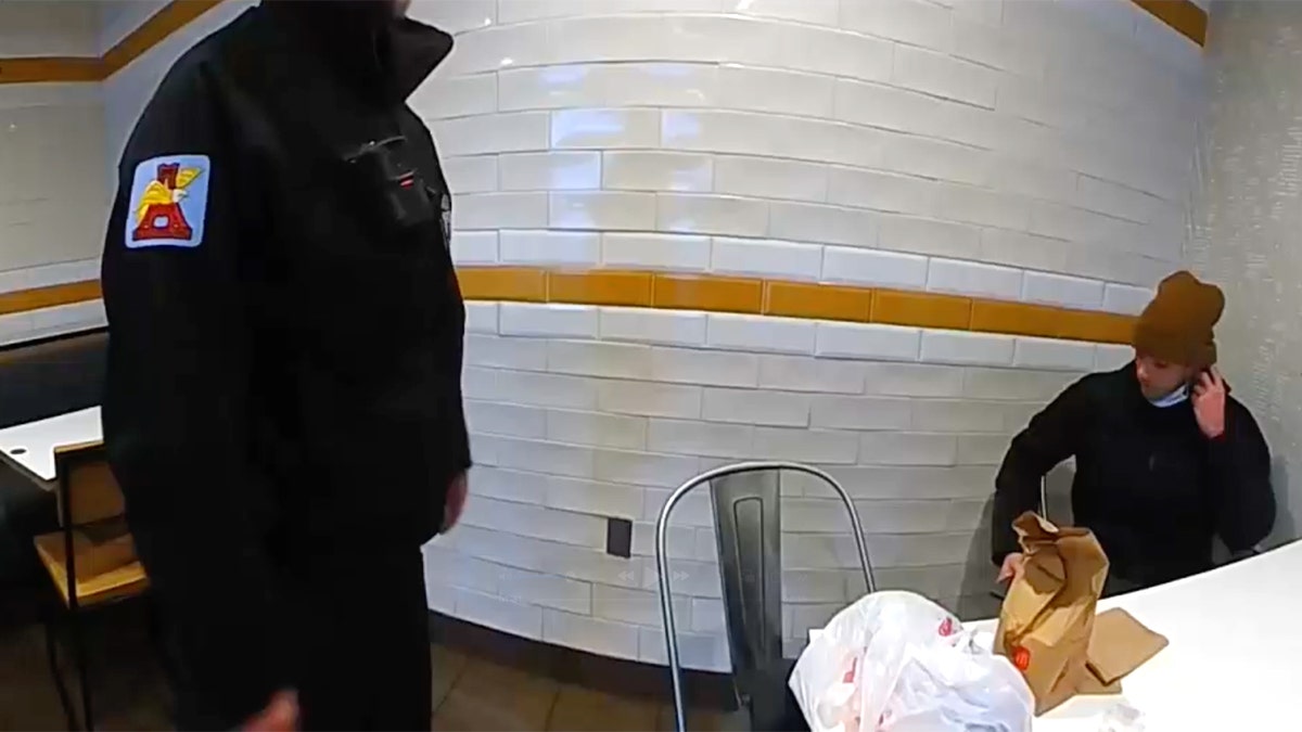 Luigi Mangione talking with a police officer in Altoona, Pennsylvania