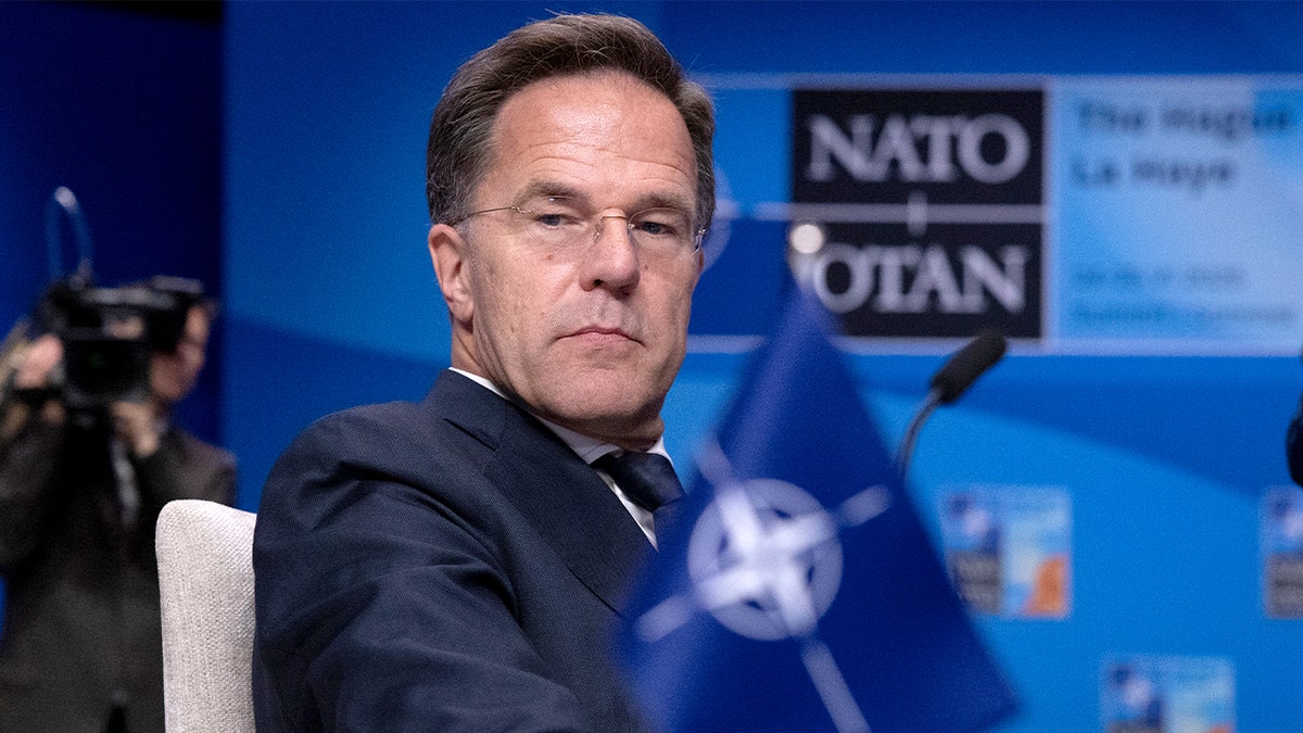 NATO Secretary General Mark Rutte sitting in a conference room prepared for a summit.