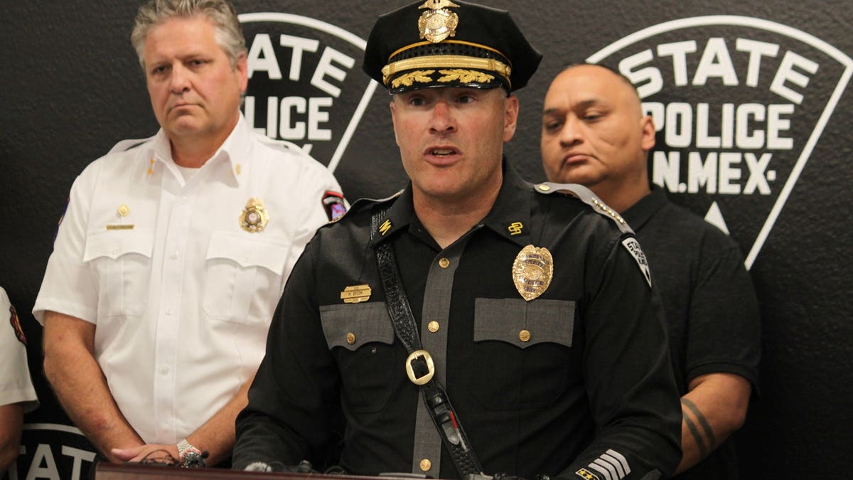 New Mexico State Police Chief Matt Broom, center, provides updates during a news conference