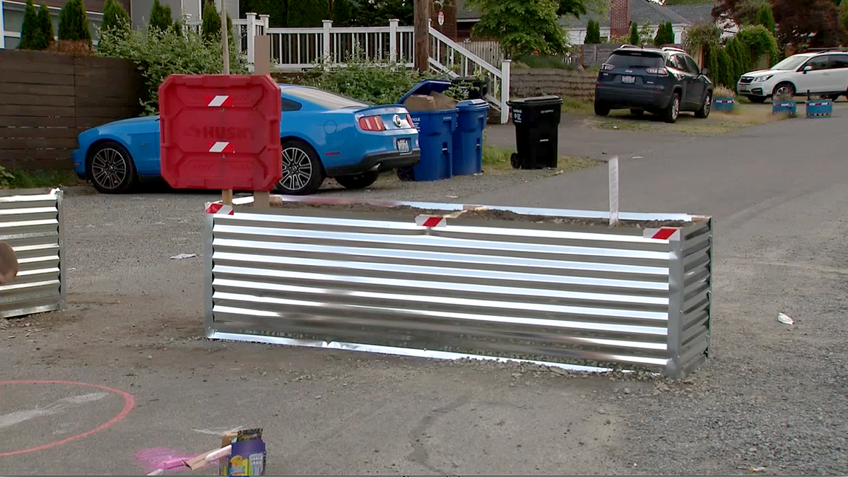 Metal barricades placed across a Seattle residential street near Aurora Avenue following violent crime incidents