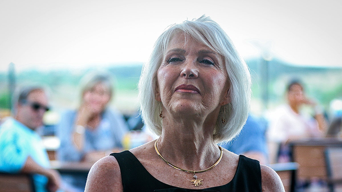 Tina Peters speaking at a podium during a public event