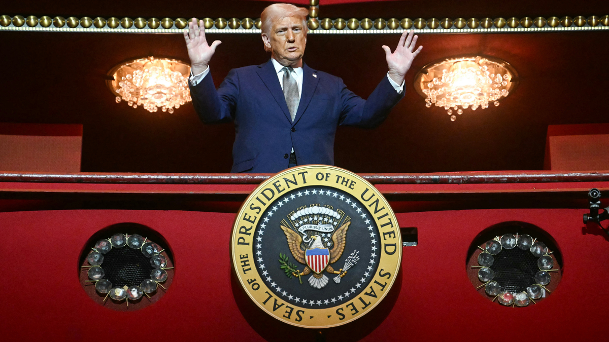 President Donald Trump standing in the presidential box at the John F. Kennedy Center for the Performing Arts