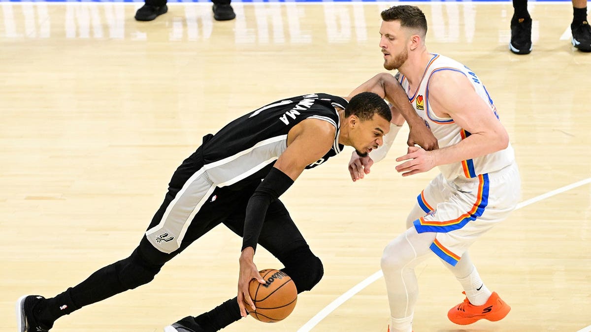 Victor Wembanyama of the San Antonio Spurs dribbling basketball against Oklahoma City Thunder