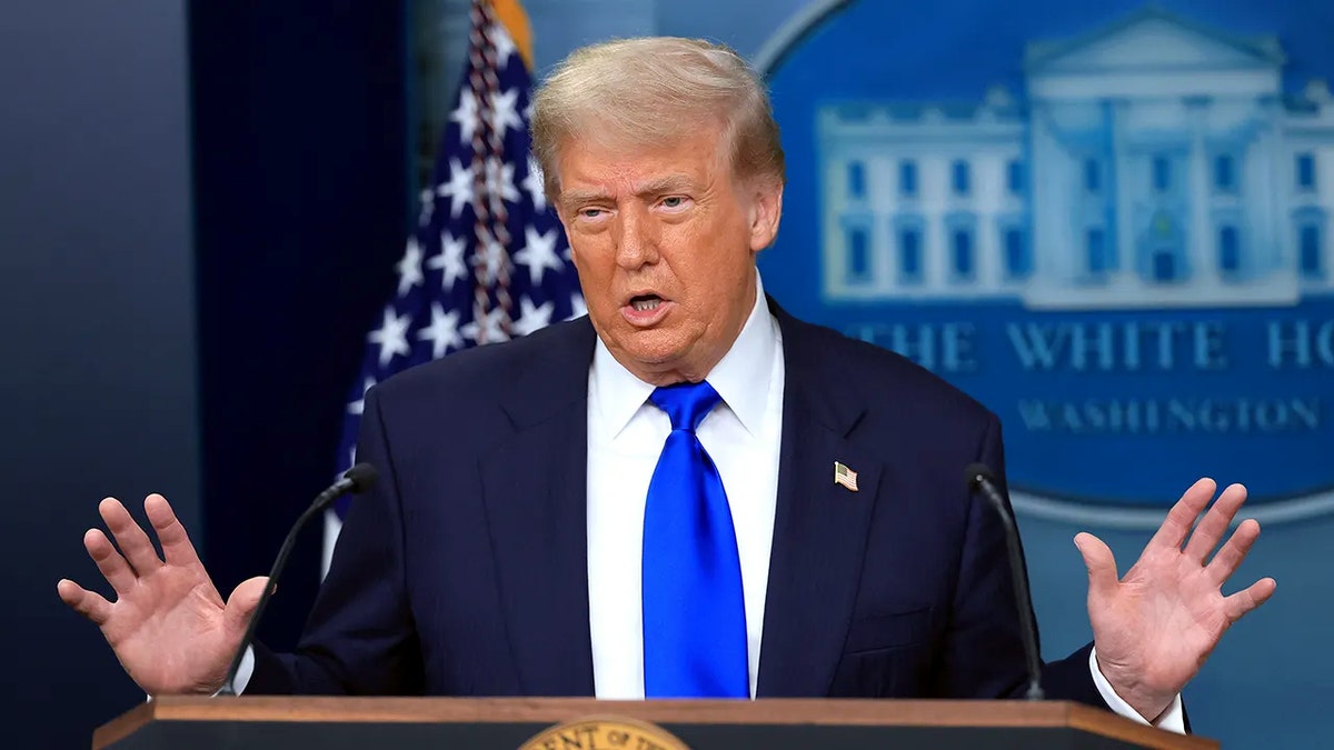 President Donald Trump speaking at a podium at the White House