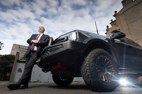 MP Jeff Bourman with his Ford Ranger in the parliamentary car park. Bourman has launched a parliamentary inquiry to consider why larger utes are charged more on toll roads. 