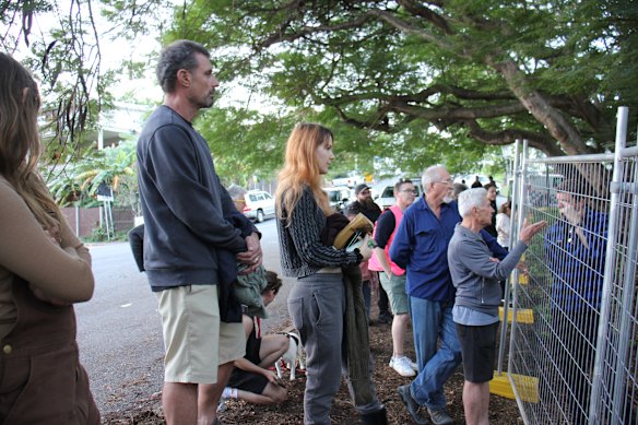Protesters gather outside the fences at Kurilpa Commons on the border of Highgate Hill and West End.