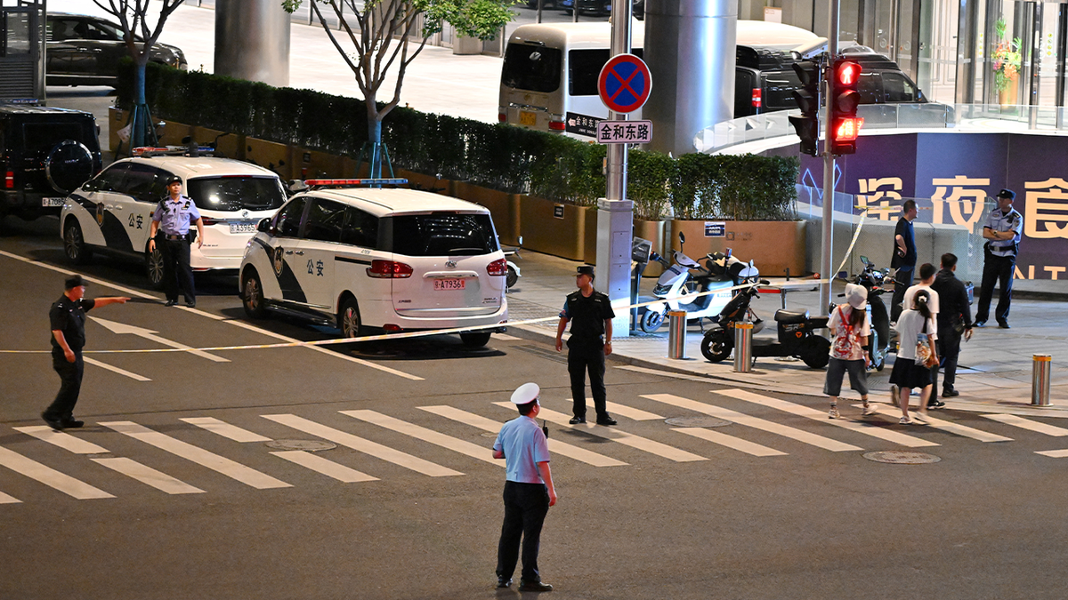 Police personnel block the road near the CITIC Tower in Beijing on June 26, 2026.