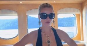 Brooks Nader Narrowly Avoids Wardrobe Malfunction While Going Braless in Plunging Dress on a Yacht