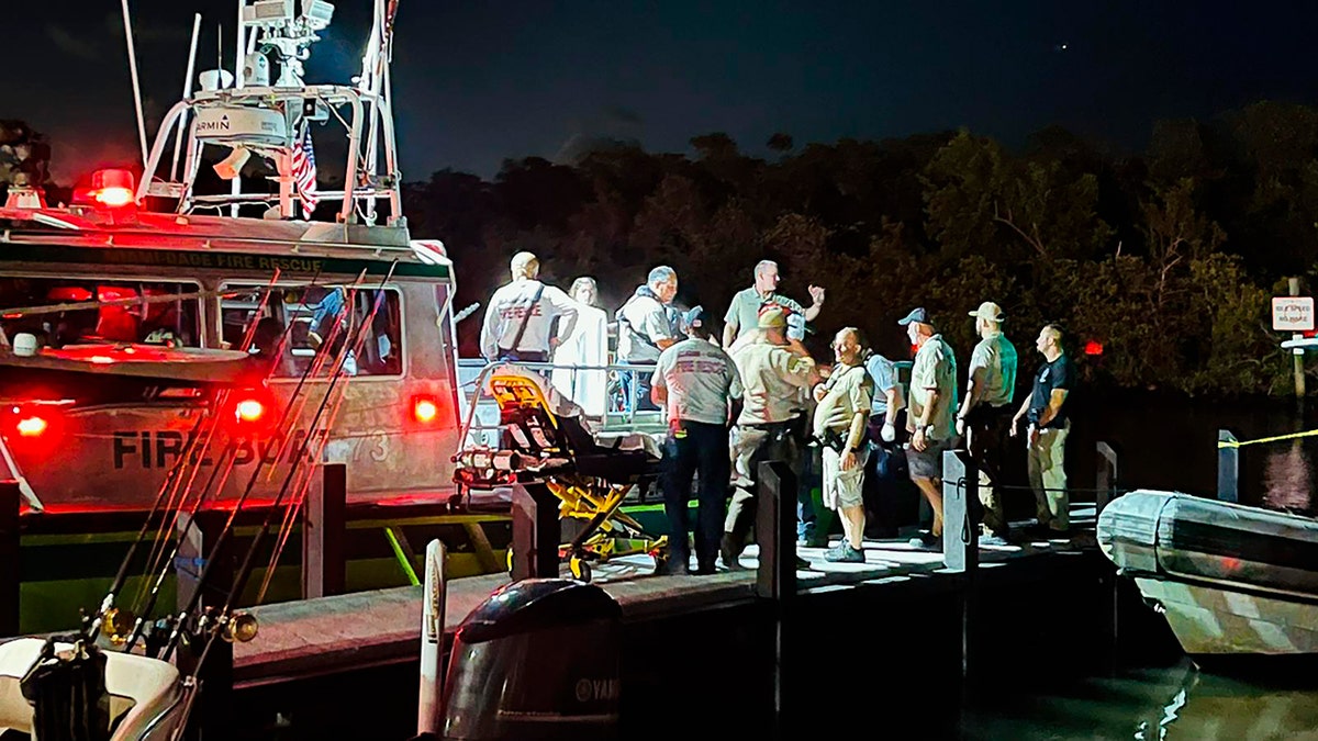 Miami-Dade Fire Rescue agents standing at the scene of a boat crash near Boca Chita Key Florida