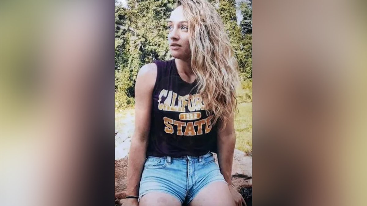 Rachel Morin standing outdoors wearing jean shorts and a California tank top