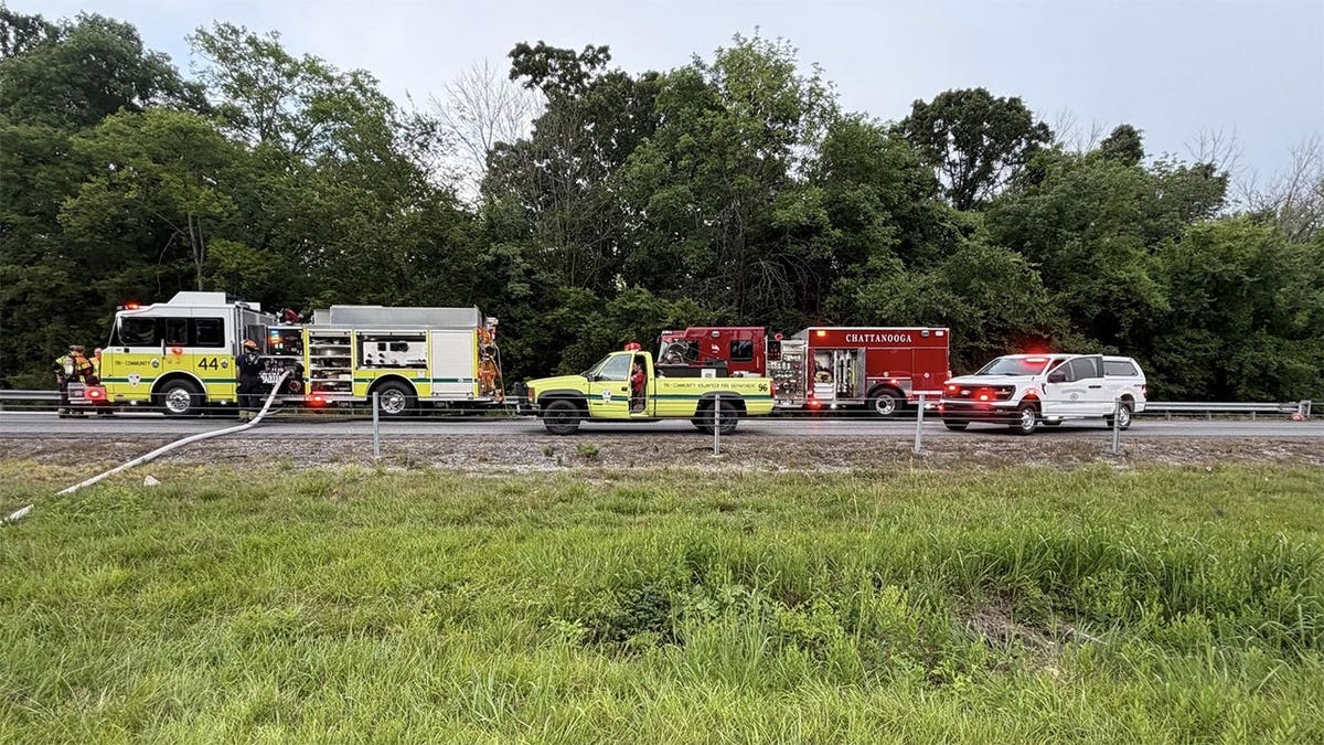 Emergency vehicles from multiple fire departments line Interstate 75 in Tennessee after a trailer carrying fireworks caught fire and triggered highway closures.